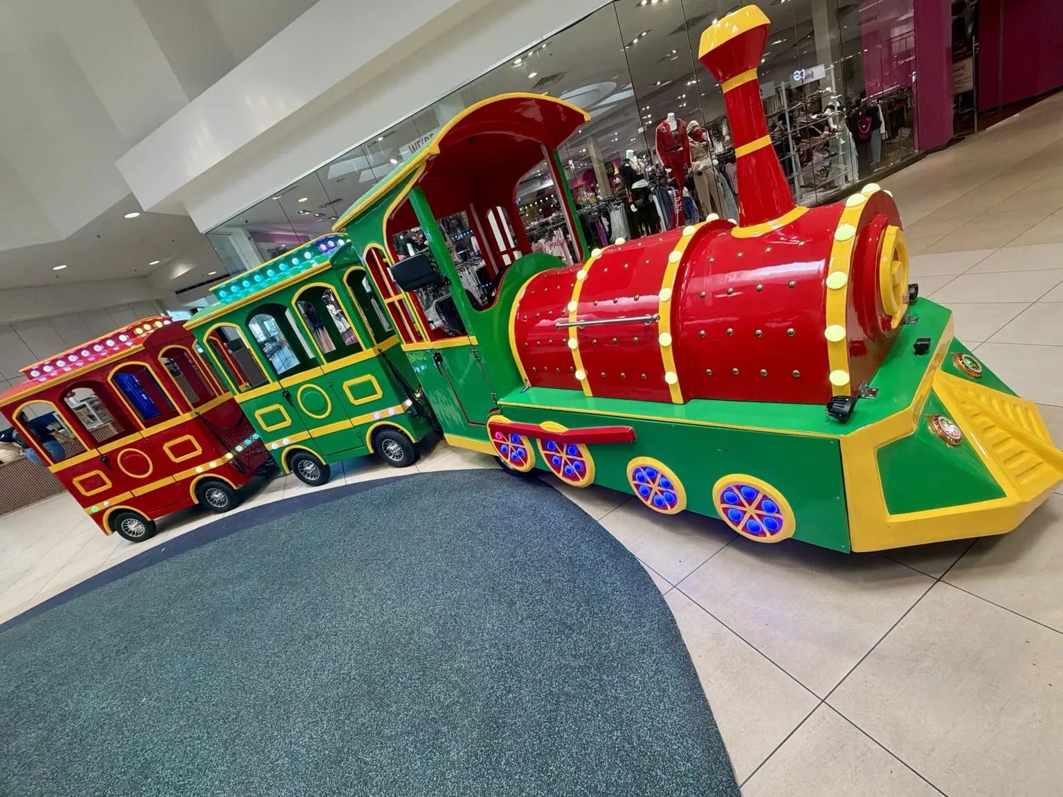 Red and green Fun Express train inside a shopping center